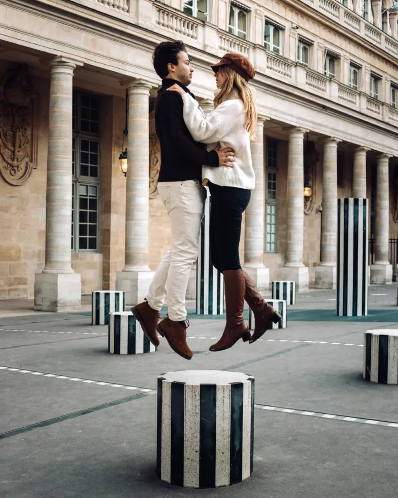 Jumping photo at the striped columns near the Louvre