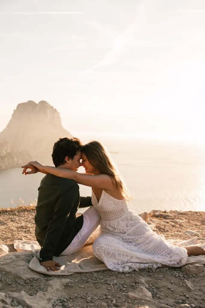 Couple at sunset facing Es Vedrà in Ibiza