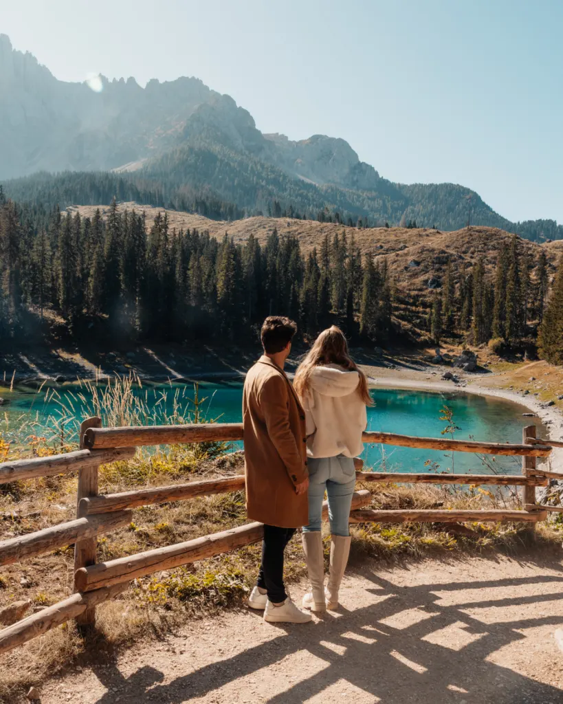 Lukas and Lore standing in front of Lago di Carezza, Karersee
