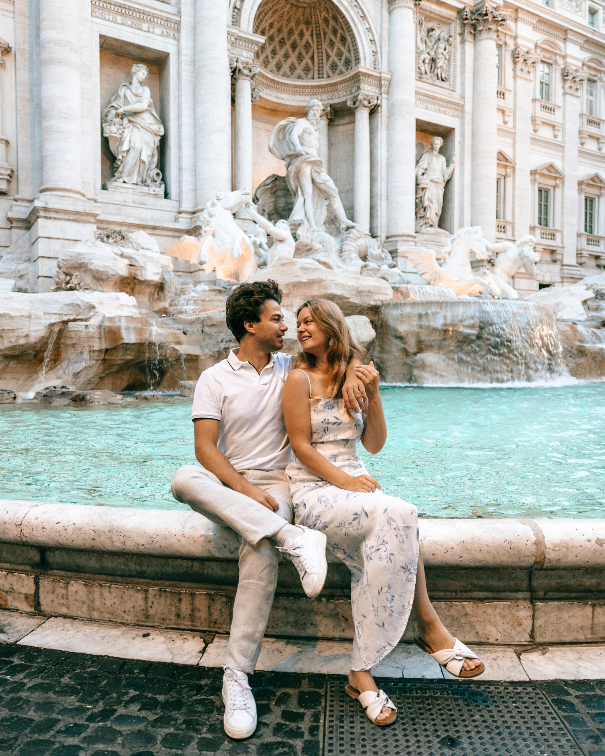 Lukas and Lore sitting at the Trevi Fountain in Rome