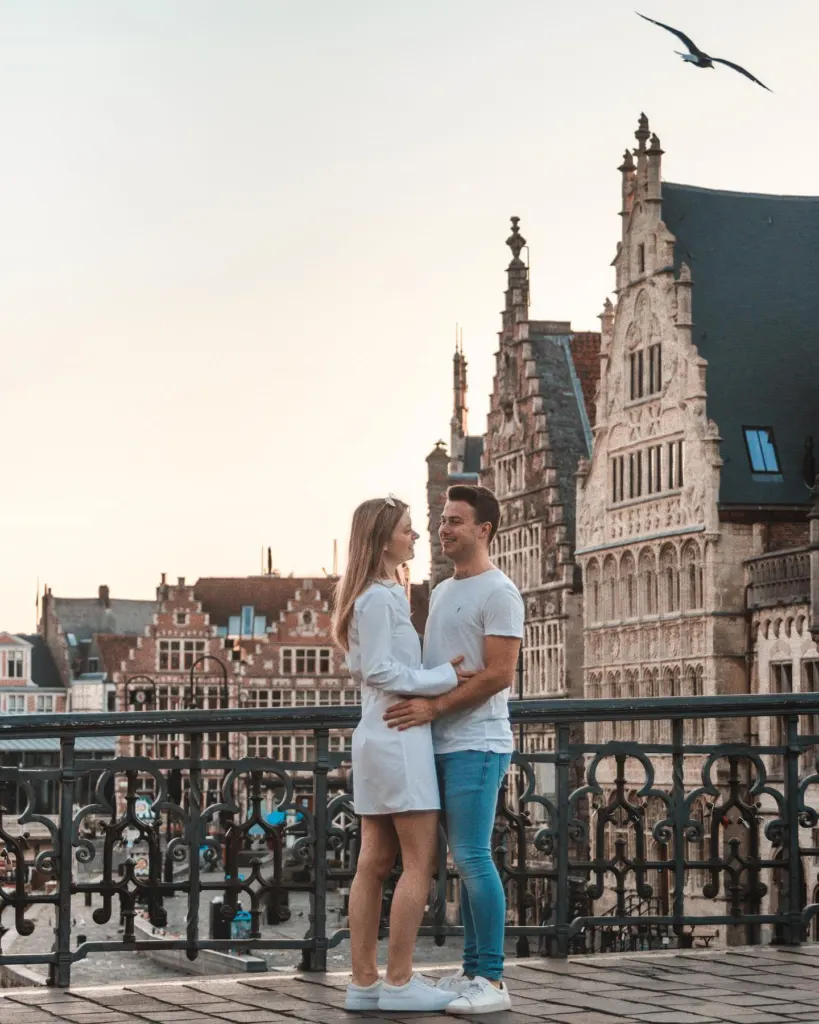 Couple in warm early light in Ghent with gabled facades in the background
